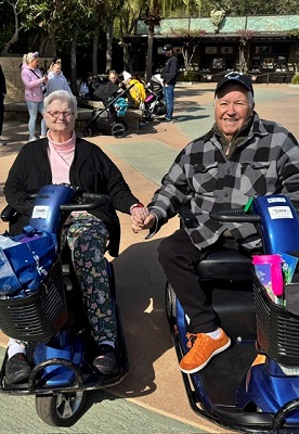 Shelly's mom and dad hold hands at Disney